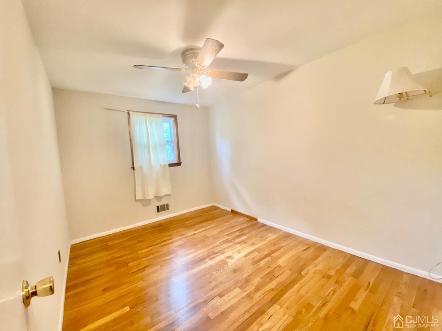 91 Holly Road Iselin, NJ 08830 - Photo 9 of 25 a view of an empty room and window