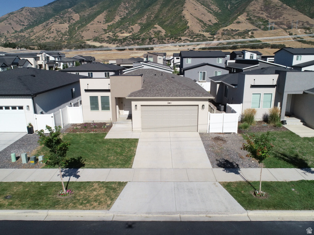 3831 South Powderwood Lane Mapleton, UT 84664 - Photo 4 of 17 Contemporary-style residence featuring a tan stucco exterior, an attached garage, and a concrete driveway