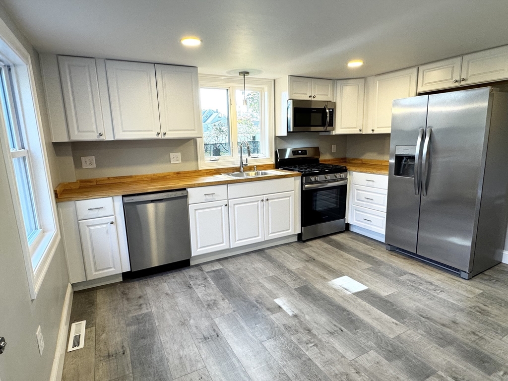 27 R Monroe Street Taunton, MA 02780 - Photo 1 of 25 a large kitchen with cabinets stainless steel appliances and a window