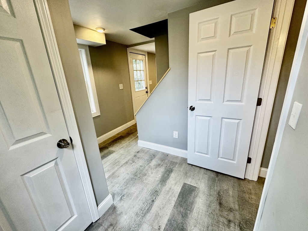 27 R Monroe Street Taunton, MA 02780 - Photo 11 of 25 a view of a hallway with wooden floor and staircase