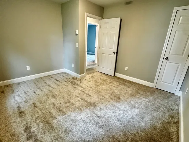 an empty room with closet area