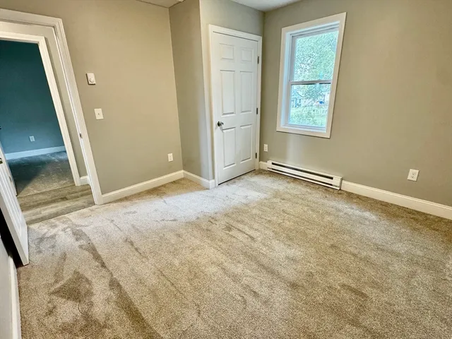 a bathroom with a bathtub toilet mirror vanity and a sink