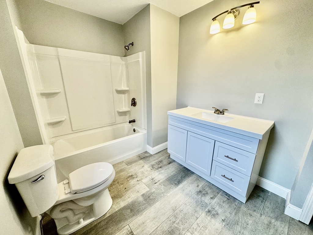 27 R Monroe Street Taunton, MA 02780 - Photo 19 of 25 a bathroom with a bathtub toilet mirror vanity and a sink