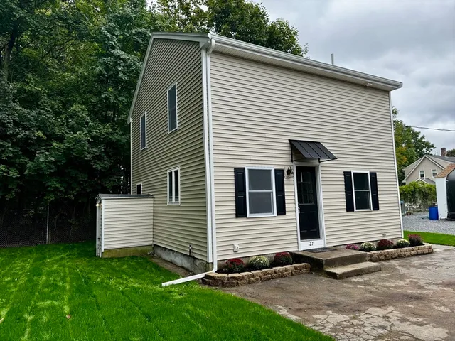 a view of a backyard with wooden fence