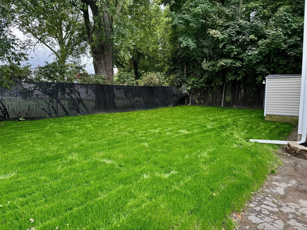 27 R Monroe Street Taunton, MA 02780 - Photo 23 of 25 a view of a backyard with wooden fence