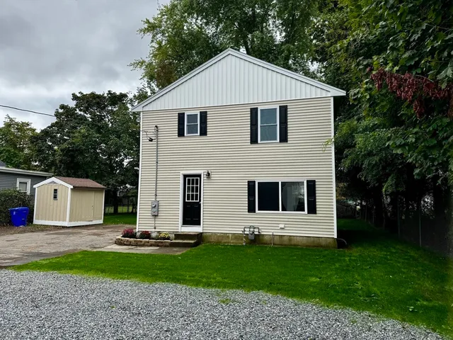 a front view of a house with a garden and garage