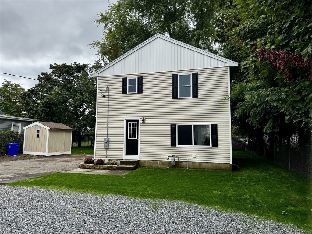 27 R Monroe Street Taunton, MA 02780 - Photo 5 of 25 a front view of a house with a garden and garage