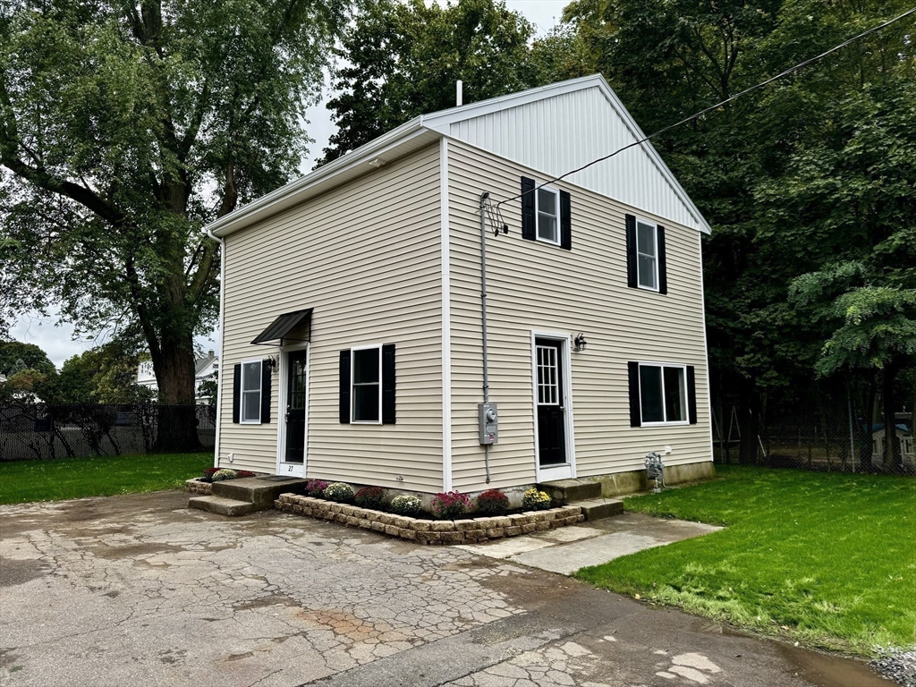 27 R Monroe Street Taunton, MA 02780 - Photo 6 of 25 a view of a white house next to a yard and large trees