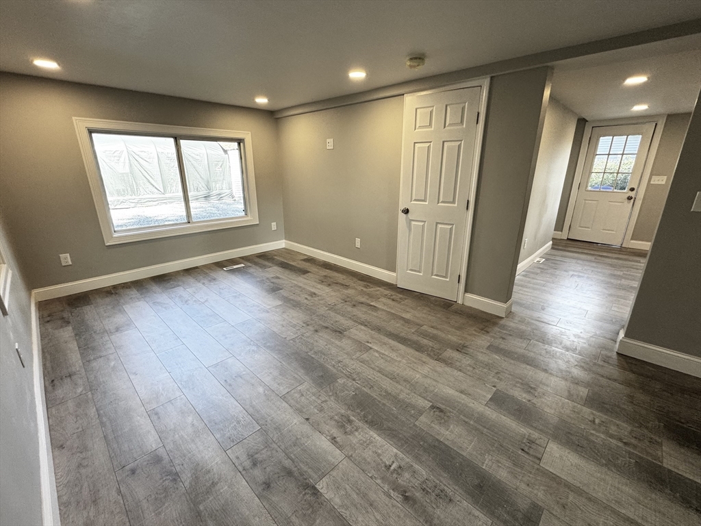 27 R Monroe Street Taunton, MA 02780 - Photo 7 of 25 an empty room with wooden floor and windows