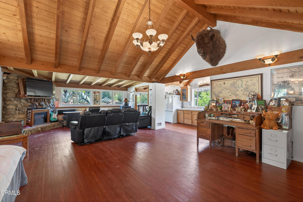 8416 Wheeler Canyon Road Santa Paula, CA 93060 - Photo 7 of 48 a living room with furniture a wooden floor and next to a window