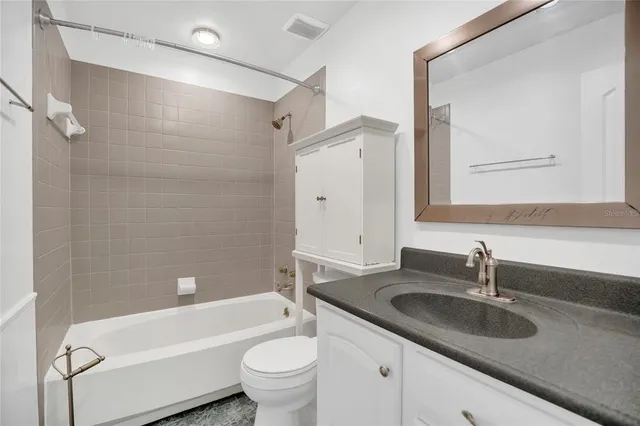 a view of a house with a yard and porch