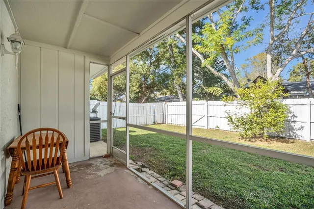 a view of a house with backyard and porch