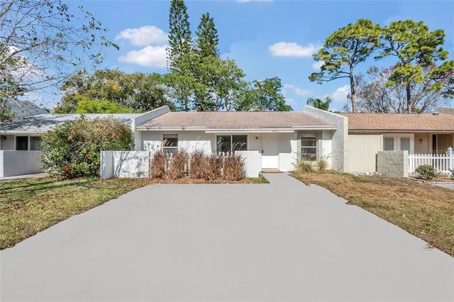 a front view of a house with a yard and a garage