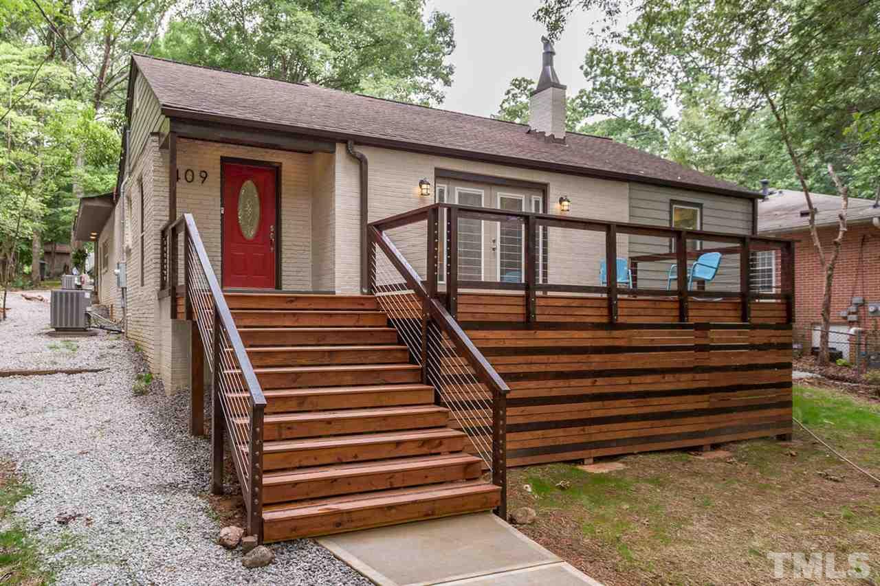409 Stacy Street Raleigh, NC 27607 - Photo 5 of 25 a front view of a house with a garden