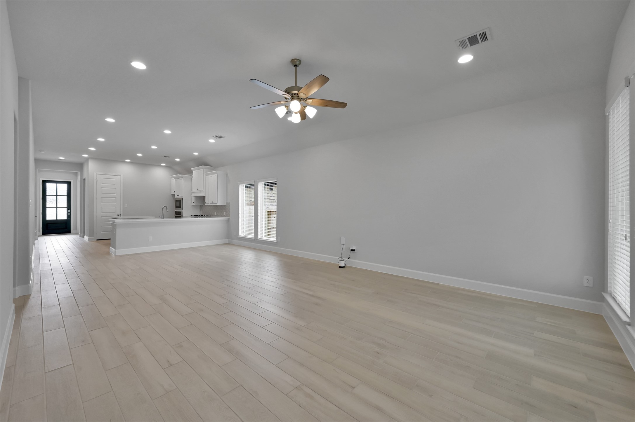 15715 Autumn Sun Conroe, TX 77302 - Photo 12 of 23 a view of an empty room with a kitchen