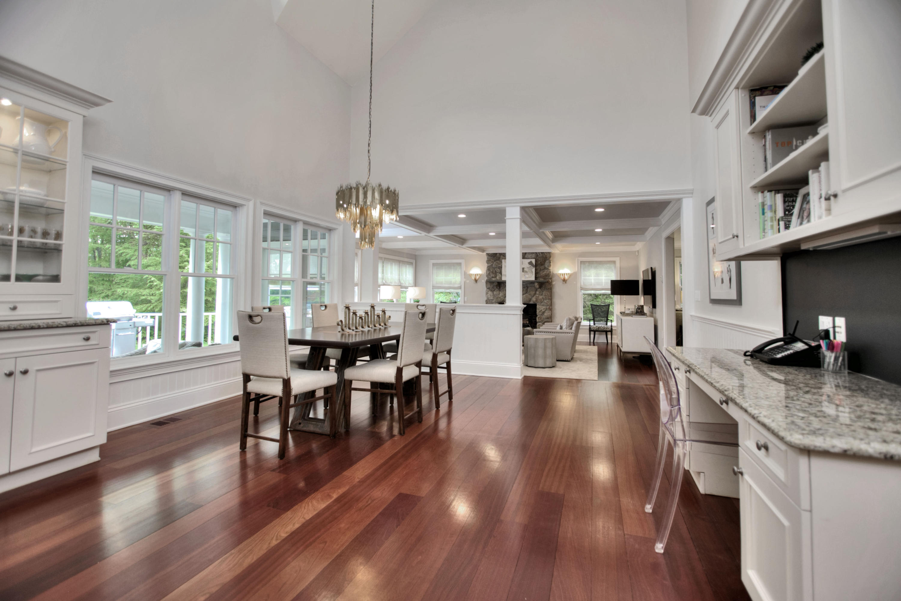 786 Cheese Spring Road New Canaan, CT 06840 - Photo 12 of 36 a view of a dining room and livingroom with furniture wooden floor a chandelier