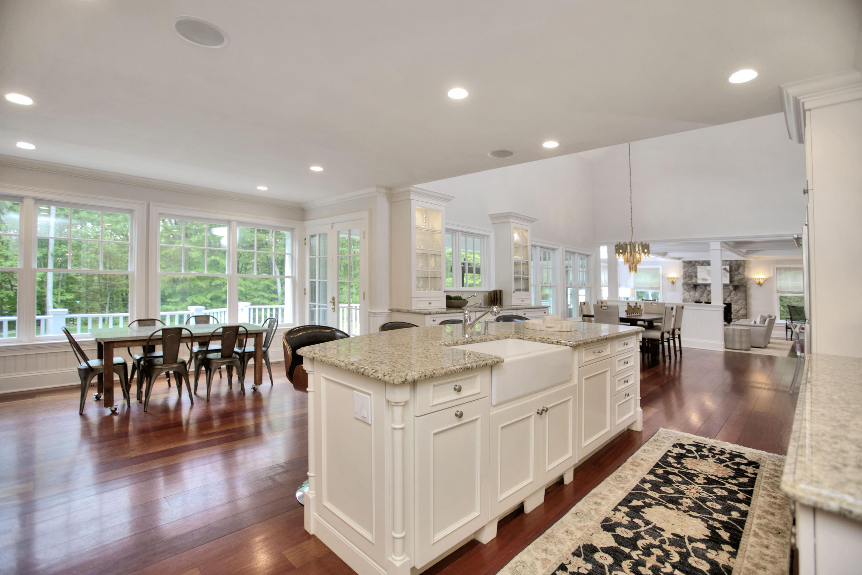 786 Cheese Spring Road New Canaan, CT 06840 - Photo 13 of 36 a large white kitchen with lots of counter space and a dining table
