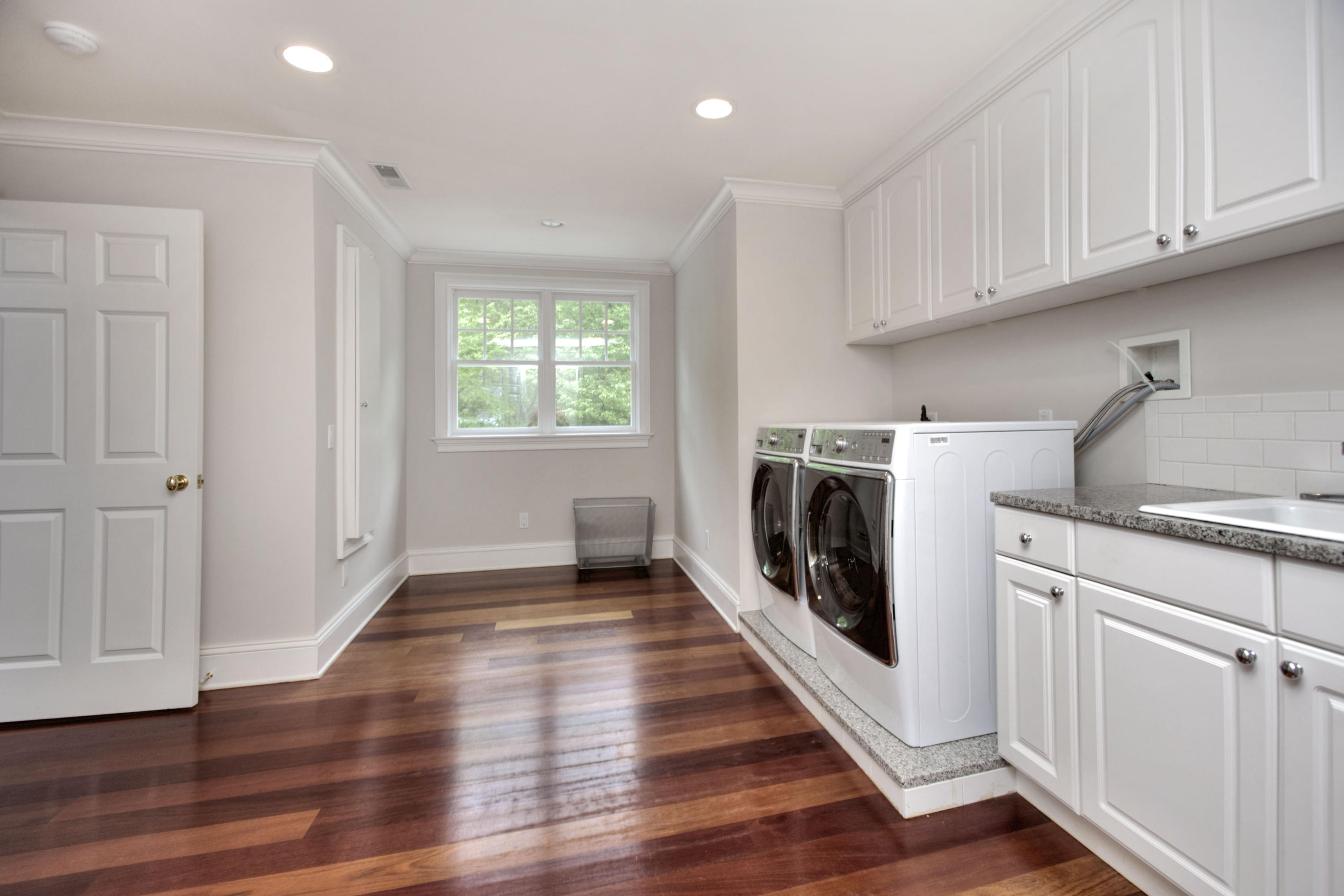 786 Cheese Spring Road New Canaan, CT 06840 - Photo 24 of 36 a kitchen with cabinets and wooden floor
