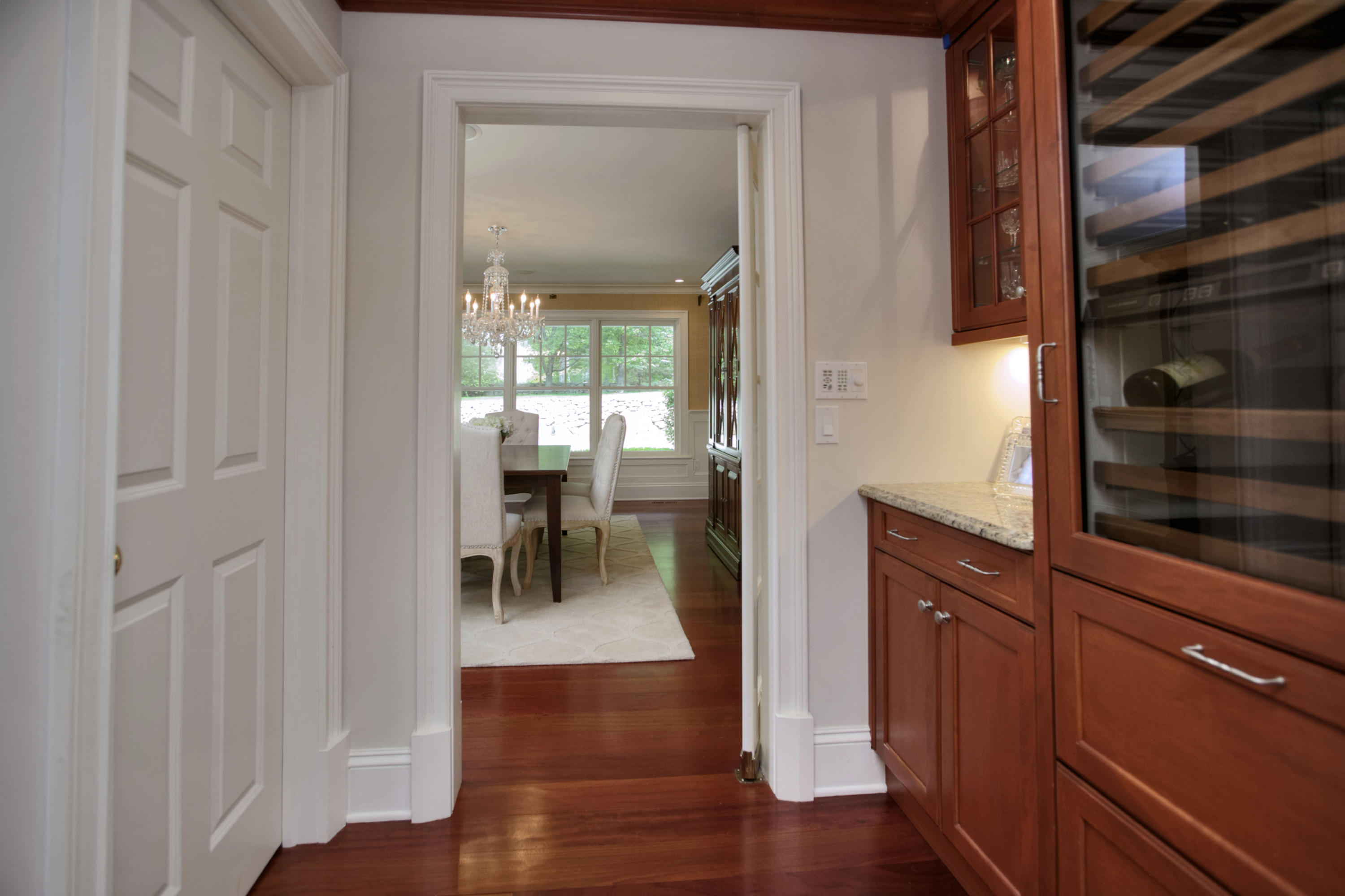 786 Cheese Spring Road New Canaan, CT 06840 - Photo 10 of 36 a view of a hallway with wooden floor windows and a bathroom