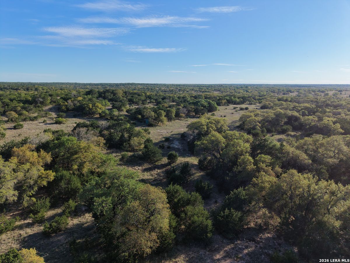 870 Rocky Top Road Southwest Hunt, TX 78024 - Photo 28 of 28 an aerial view of house with yard and mountain view in back