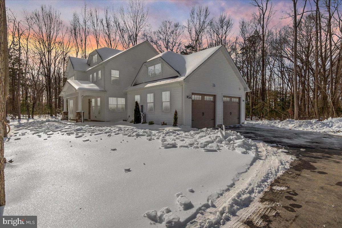 1379 Mc Donald Road Shady Side, MD 20764 - Photo 5 of 55 a view of a white house with a yard covered in snow