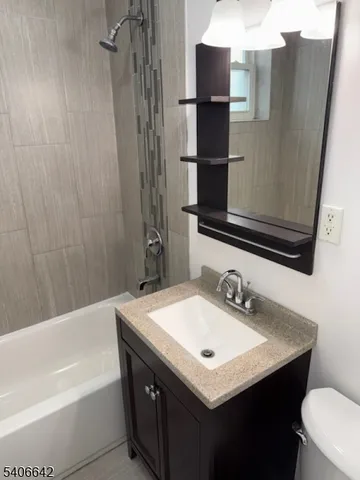 a bathroom with a sink a toilet and bathtub
