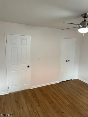 a view of a room with wooden floor