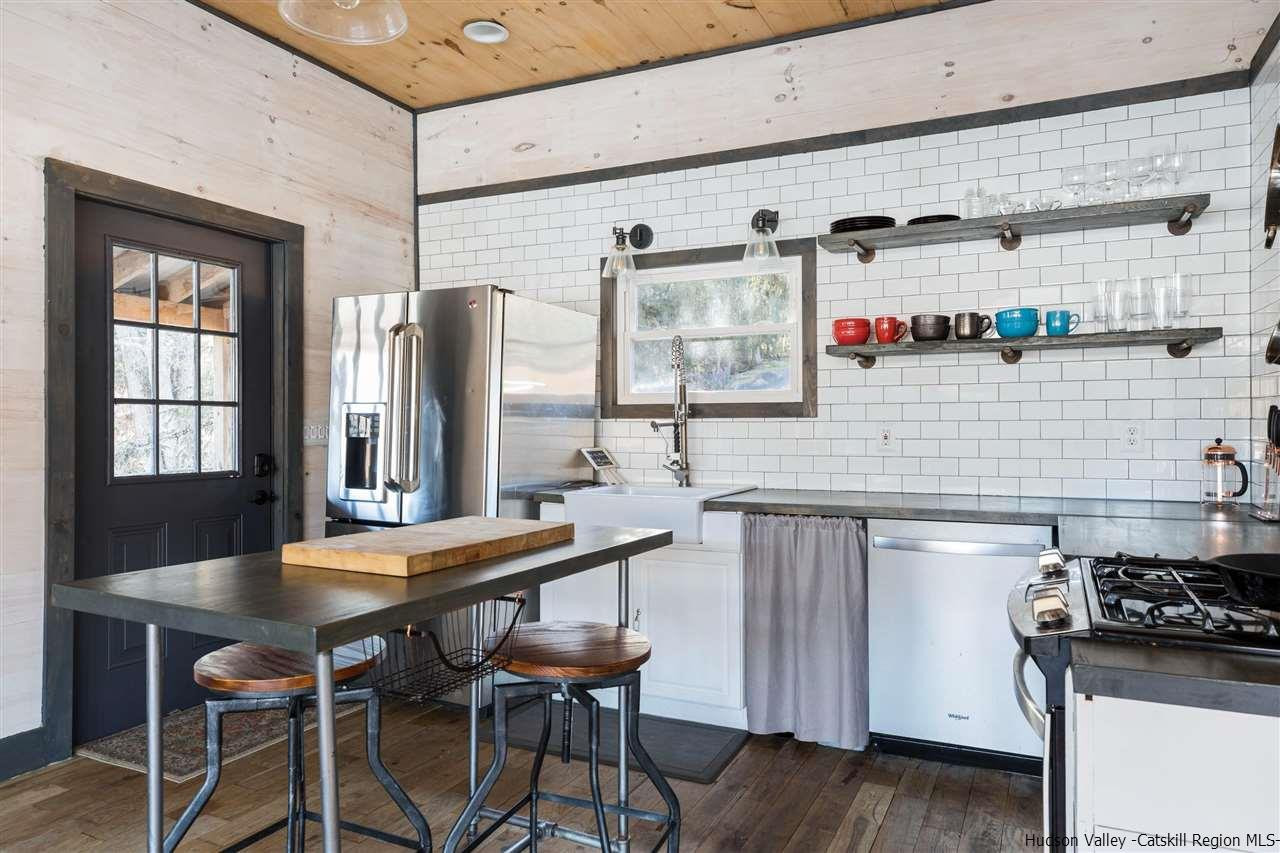 212 Trout Brook Road Roscoe, NY 12776 - Photo 13 of 35 a kitchen with stainless steel appliances granite countertop a stove and a refrigerator