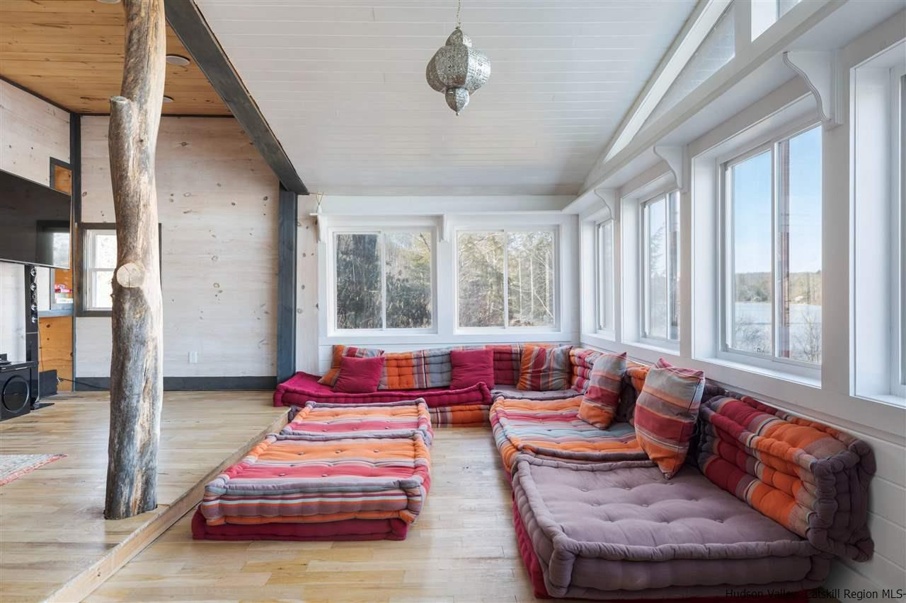 212 Trout Brook Road Roscoe, NY 12776 - Photo 19 of 35 a living room with furniture and floor to ceiling windows