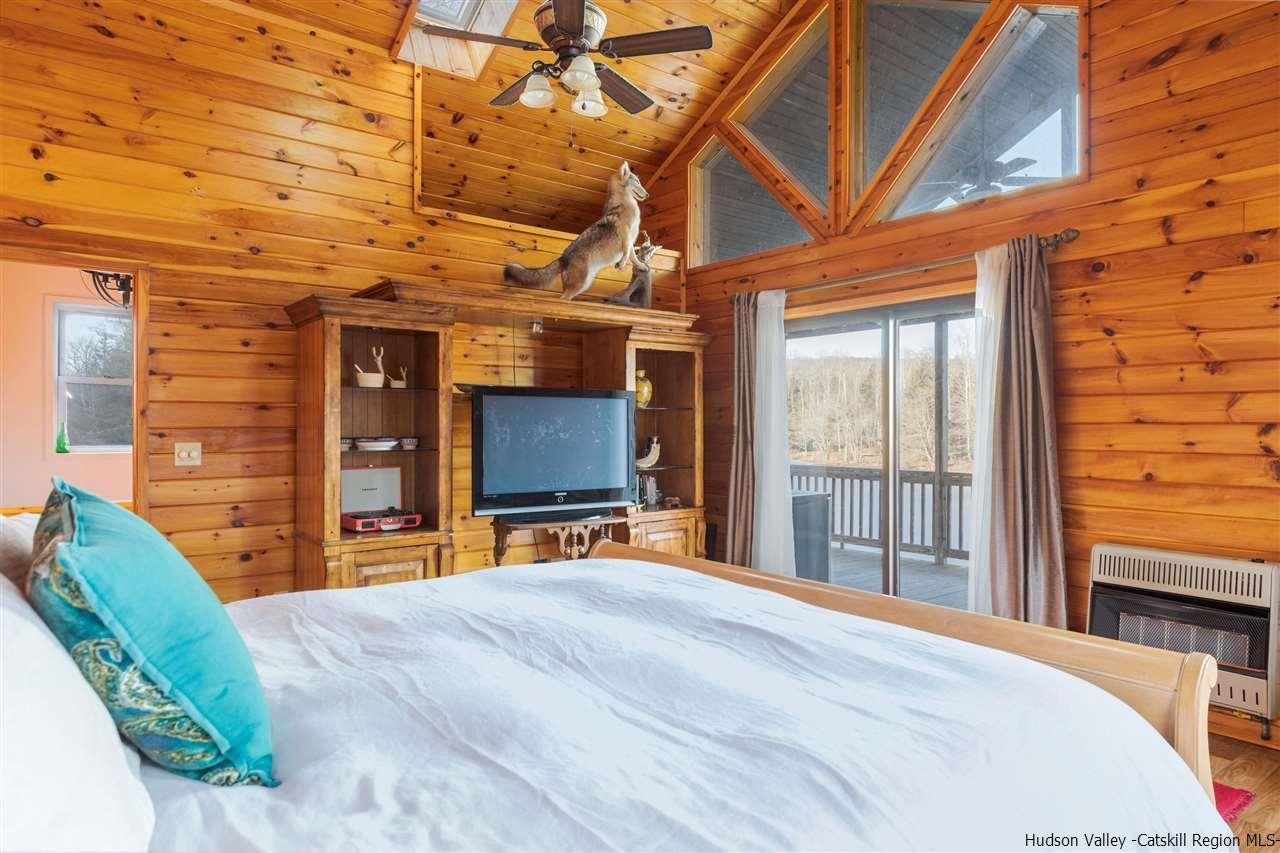 212 Trout Brook Road Roscoe, NY 12776 - Photo 23 of 35 a bedroom with a bed and a flat tv screen