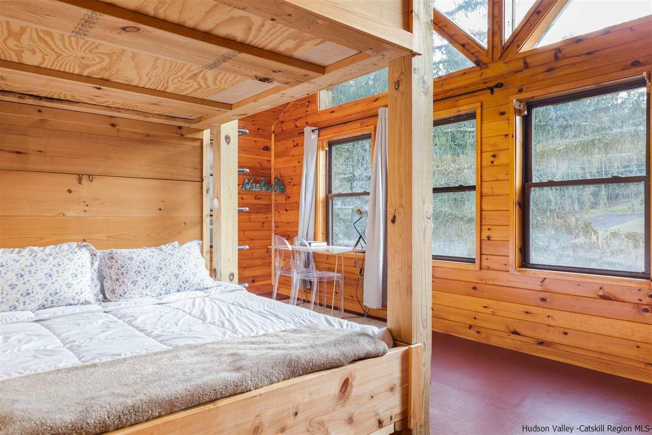 212 Trout Brook Road Roscoe, NY 12776 - Photo 26 of 35 a bedroom with a bed and wooden floor