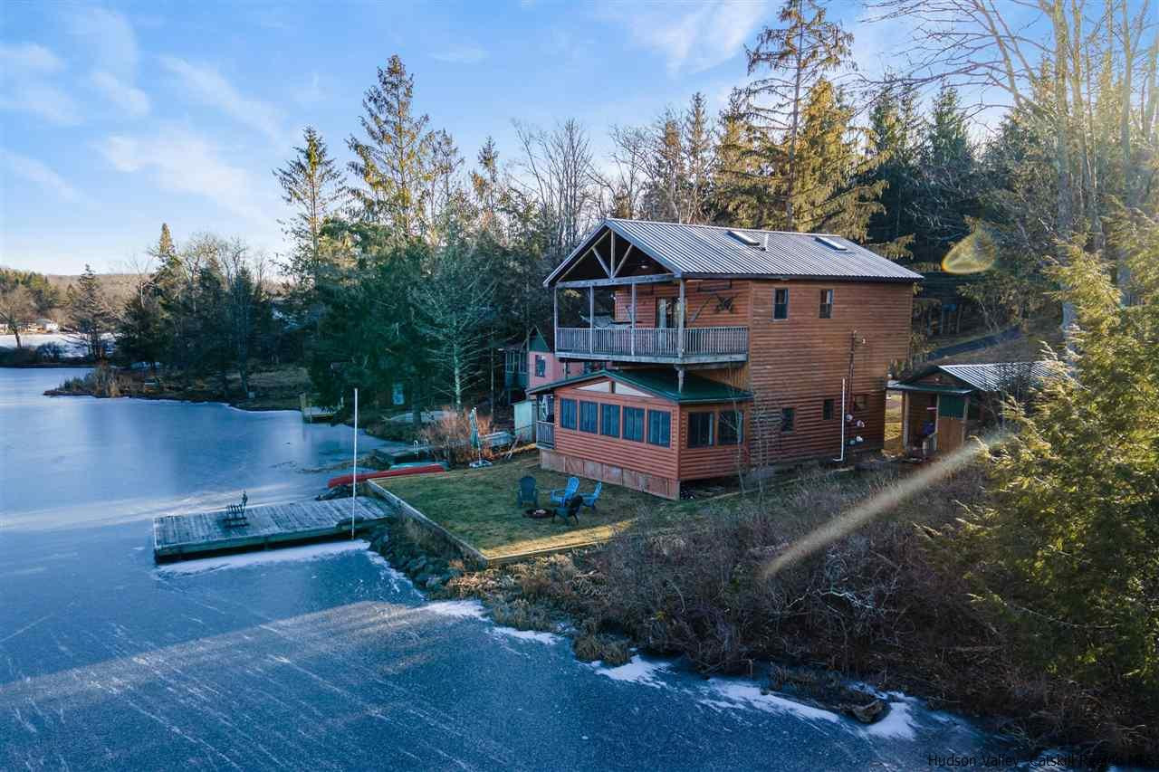 212 Trout Brook Road Roscoe, NY 12776 - Photo 30 of 35 a view of a house with wooden deck next to a yard