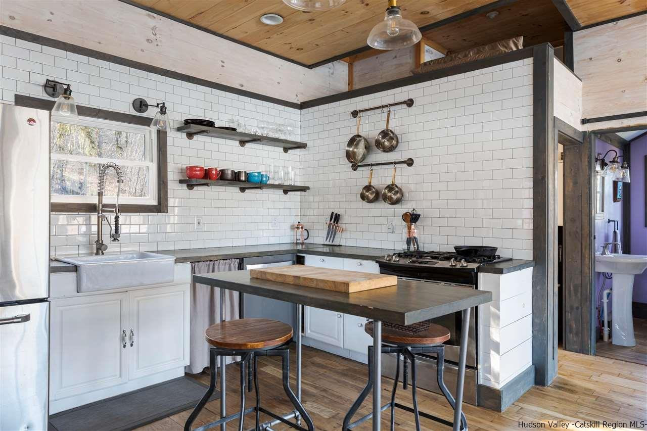 212 Trout Brook Road Roscoe, NY 12776 - Photo 4 of 35 a view of a kitchen with a table and chairs in it