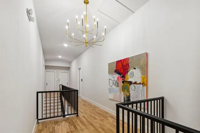 a view of a hallway with wooden floor