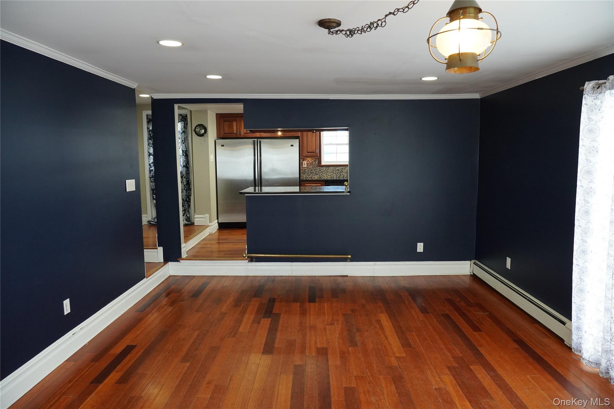 21 Potter Street Patchogue, NY 11772 - Photo 12 of 22 an empty room with wooden floor and windows