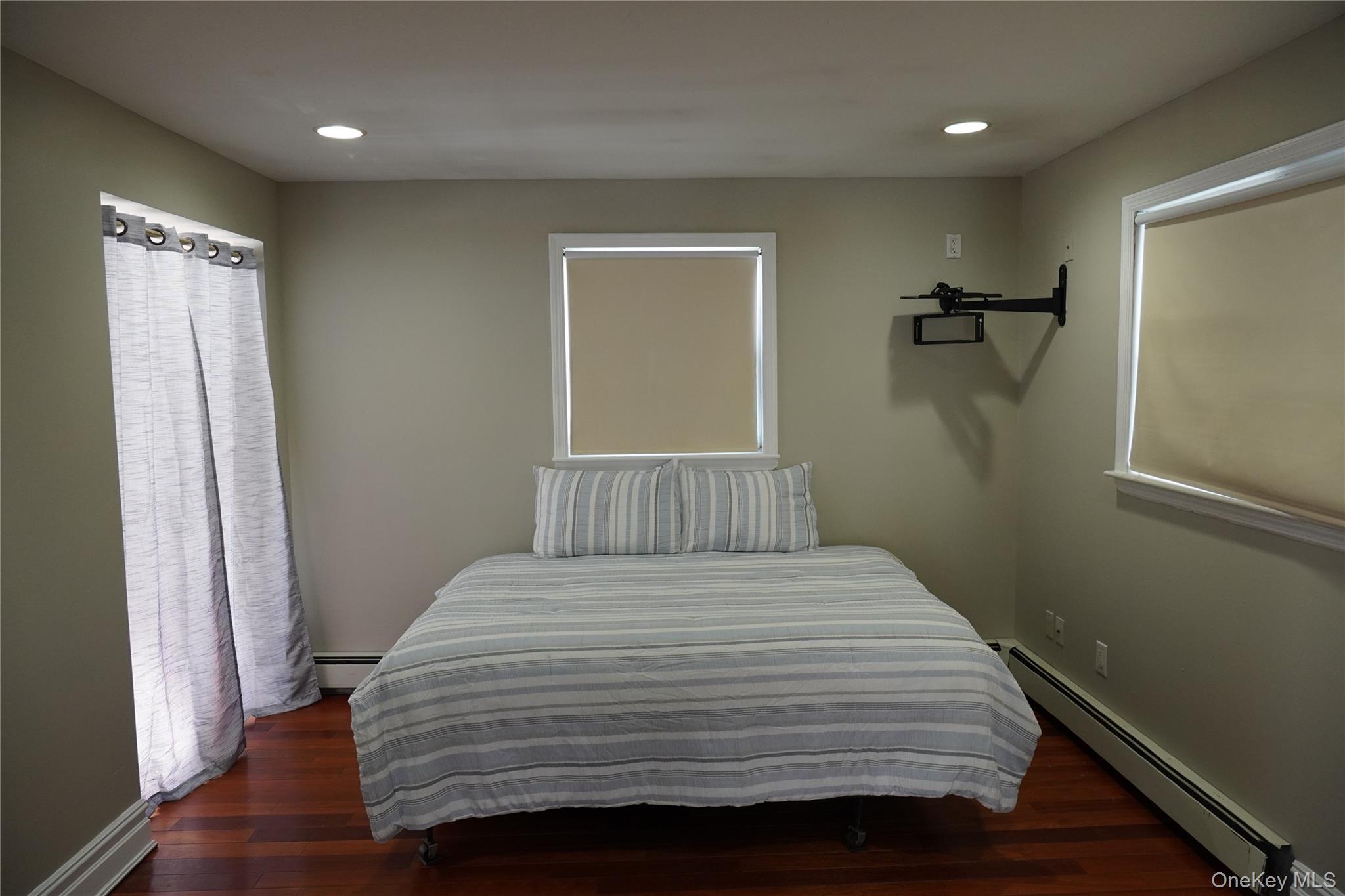 21 Potter Street Patchogue, NY 11772 - Photo 13 of 22 a bedroom with a bed and a window
