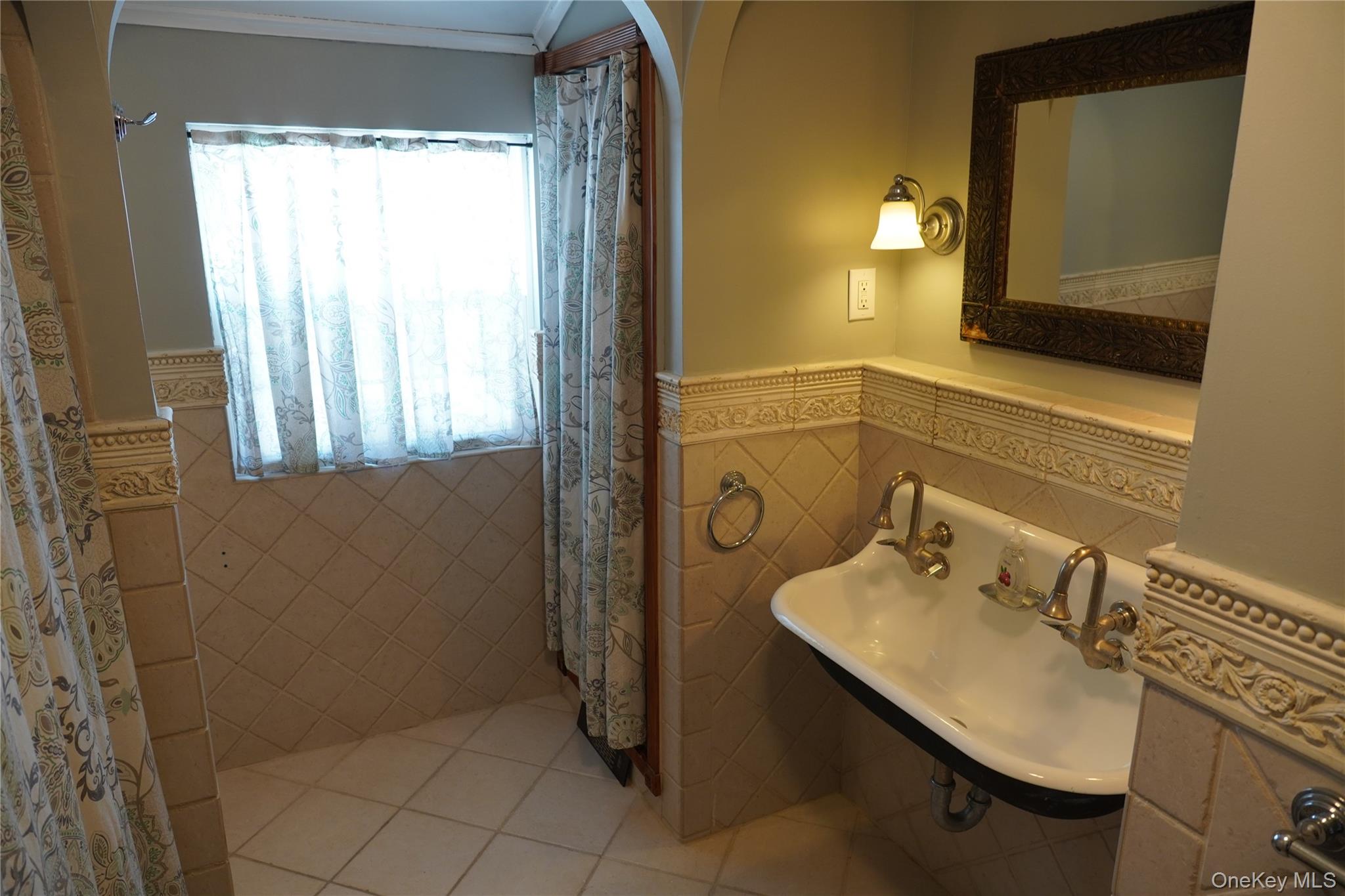 21 Potter Street Patchogue, NY 11772 - Photo 18 of 22 a bathroom with a sink and a mirror