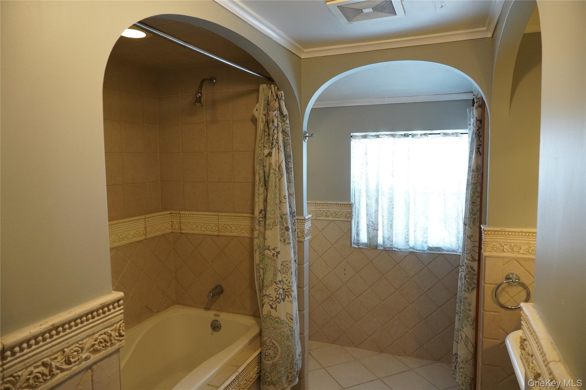 21 Potter Street Patchogue, NY 11772 - Photo 19 of 22 a bathroom with a tub and a shower