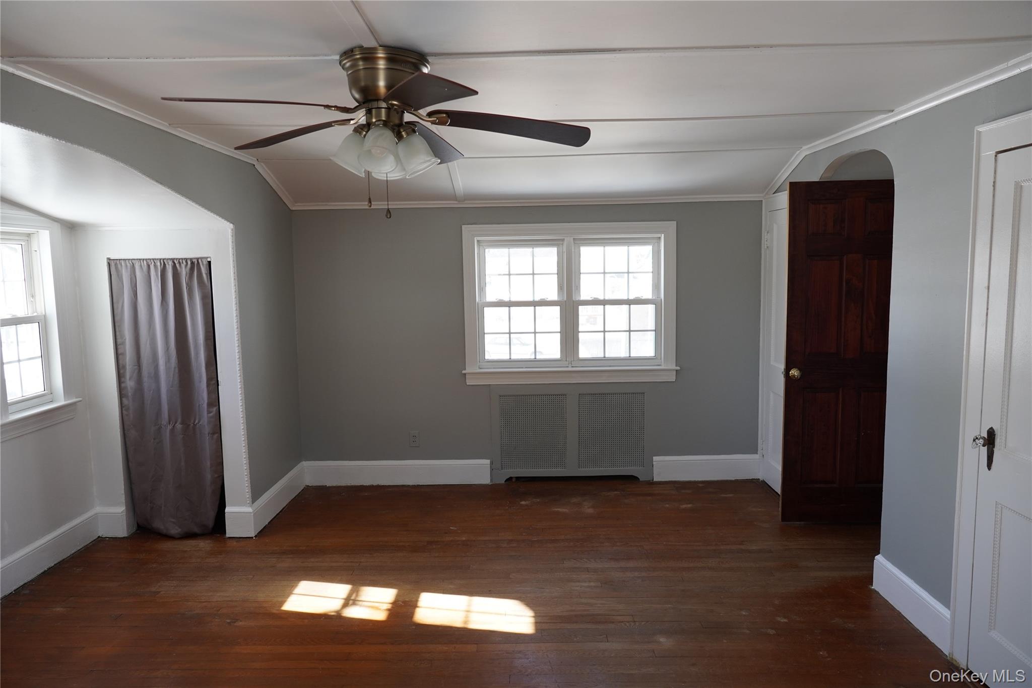 21 Potter Street Patchogue, NY 11772 - Photo 21 of 22 a view of empty room with wooden floor and fan