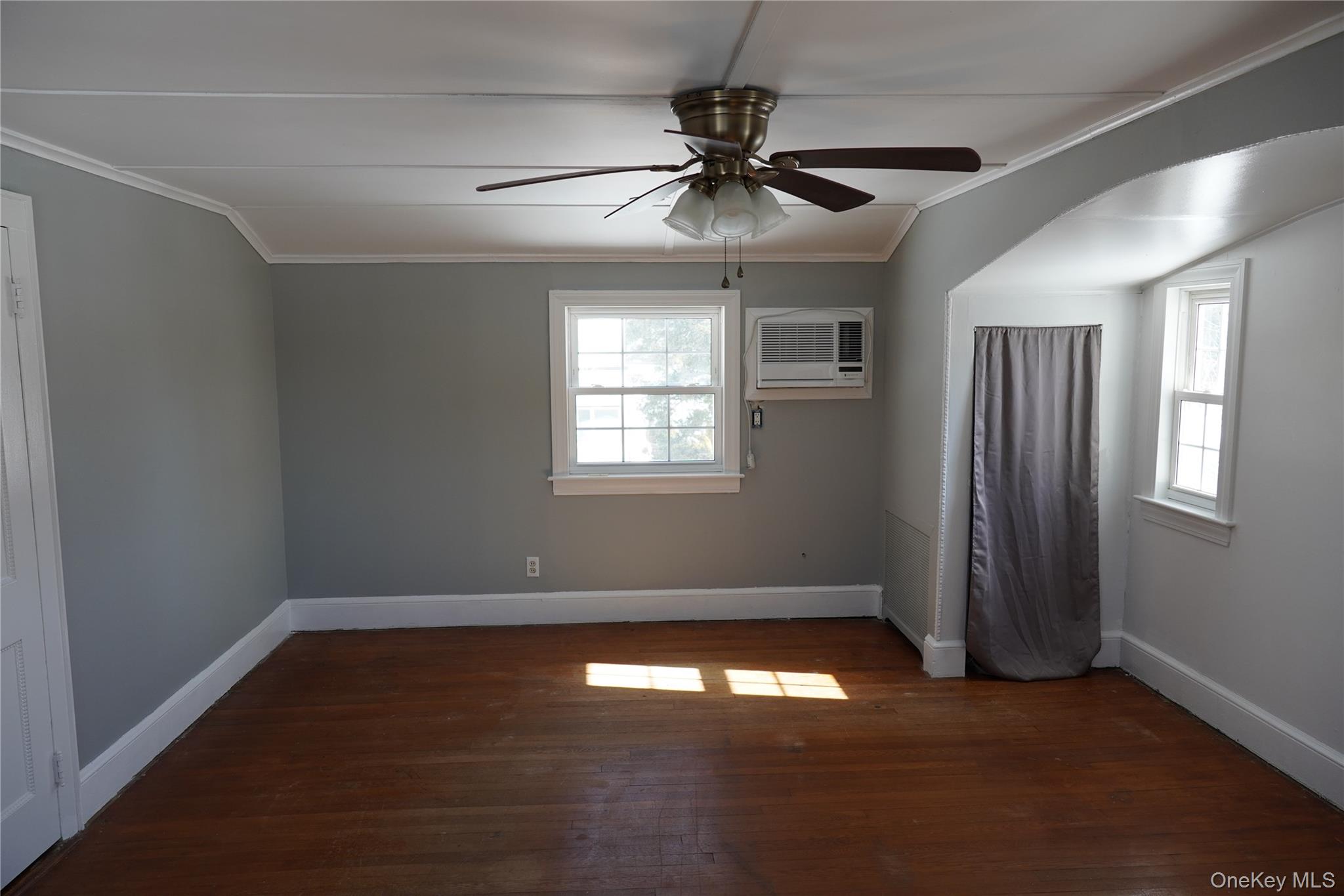 21 Potter Street Patchogue, NY 11772 - Photo 22 of 22 a view of empty room with wooden floor and fan