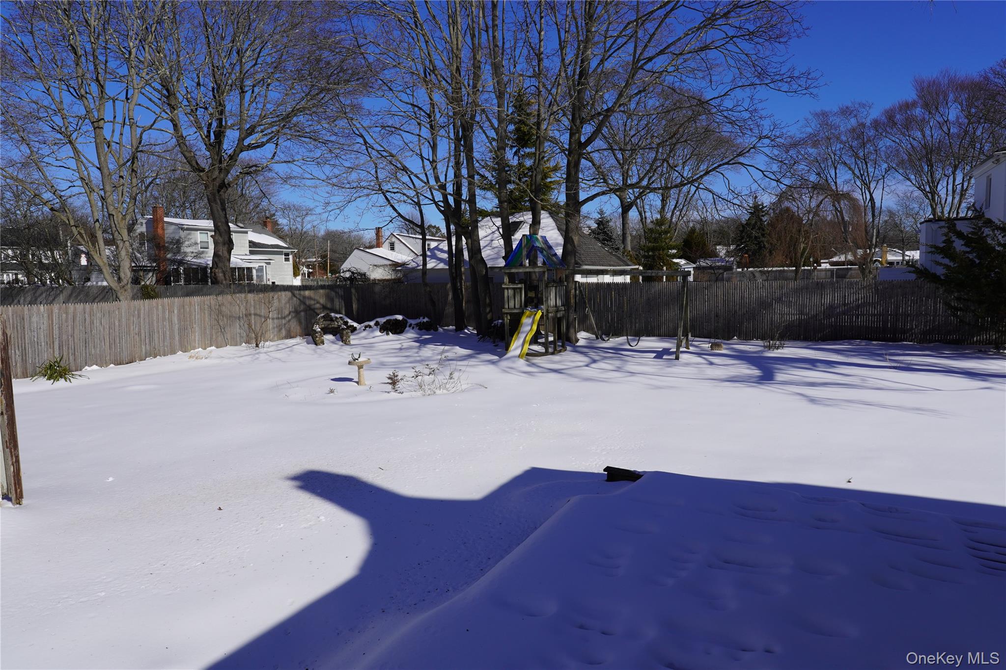 21 Potter Street Patchogue, NY 11772 - Photo 4 of 22 a view of snow on the side of house