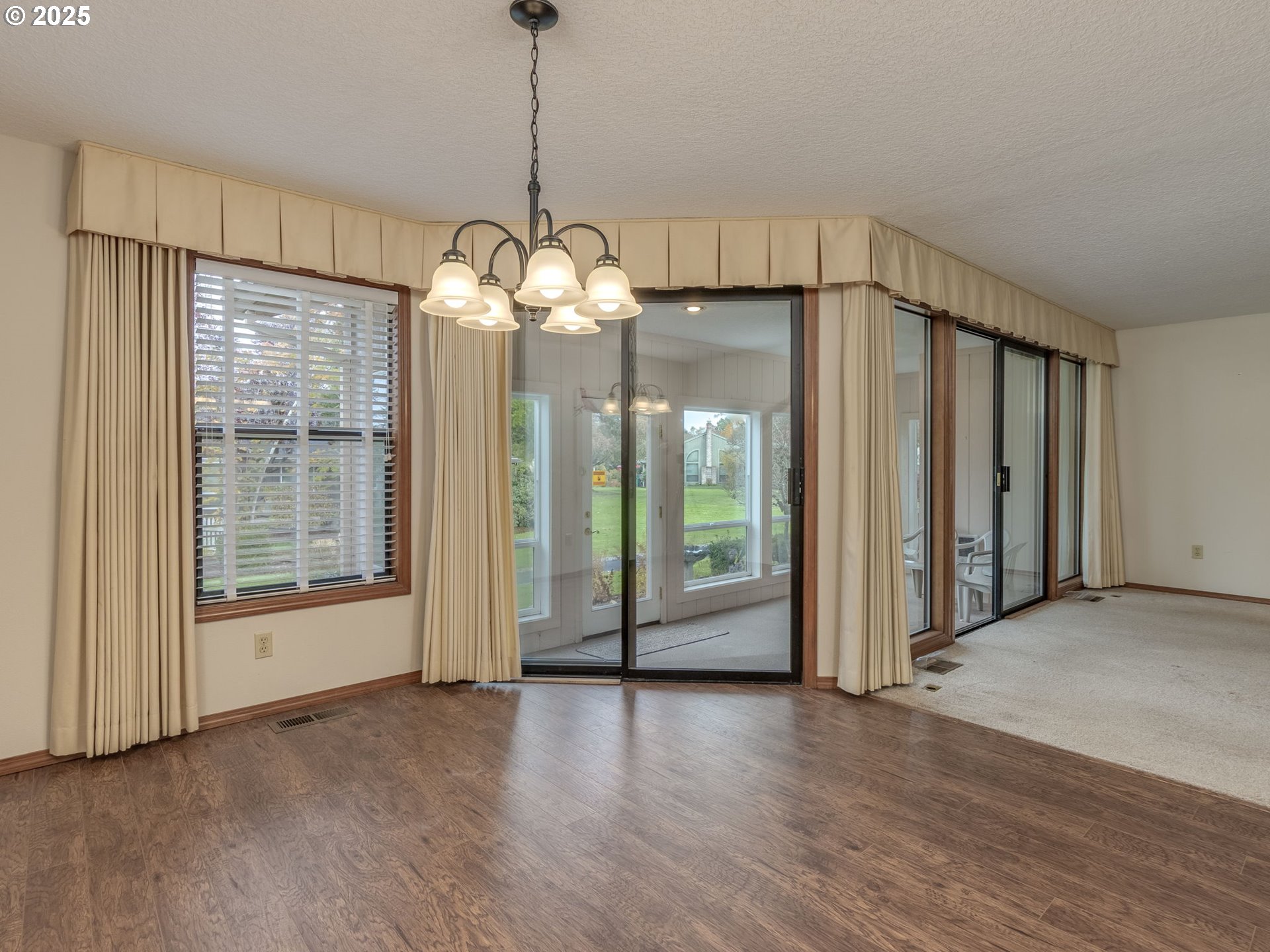 2328 Northeast 156th Place Portland, OR 97230 - Photo 14 of 41 a view of a livingroom with a chandelier wooden floor and door