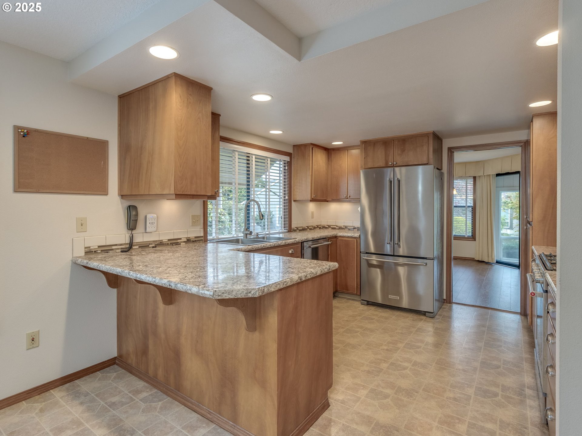 2328 Northeast 156th Place Portland, OR 97230 - Photo 15 of 41 a kitchen with stainless steel appliances granite countertop a sink a refrigerator and a stove