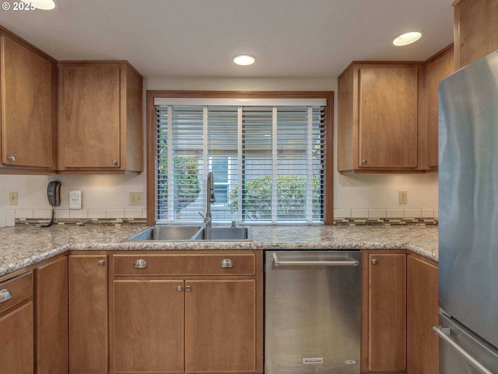 2328 Northeast 156th Place Portland, OR 97230 - Photo 17 of 41 a kitchen with granite countertop cabinets sink and window stainless steel appliances