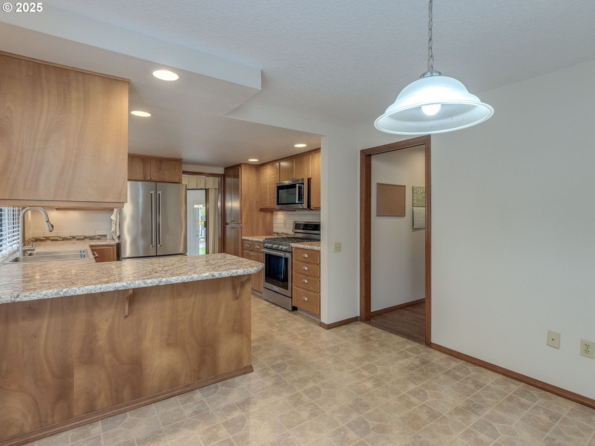 2328 Northeast 156th Place Portland, OR 97230 - Photo 22 of 41 a large kitchen with stainless steel appliances granite countertop a sink a stove and refrigerator