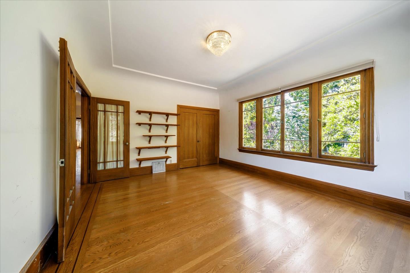 167 Almendral Avenue Atherton, CA 94027 - Photo 11 of 50 a view of an empty room with a window and wooden floor