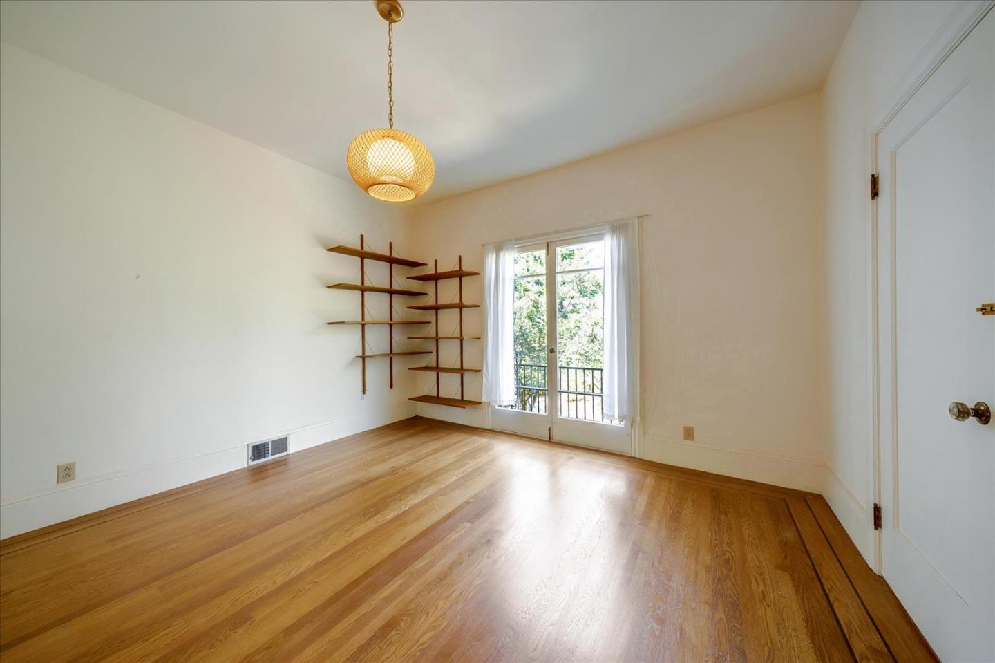167 Almendral Avenue Atherton, CA 94027 - Photo 14 of 50 a view of an empty room with wooden floor and a window