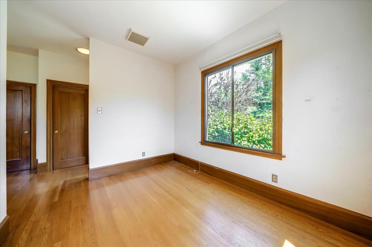 167 Almendral Avenue Atherton, CA 94027 - Photo 17 of 50 a view of an empty room with wooden floor and a window