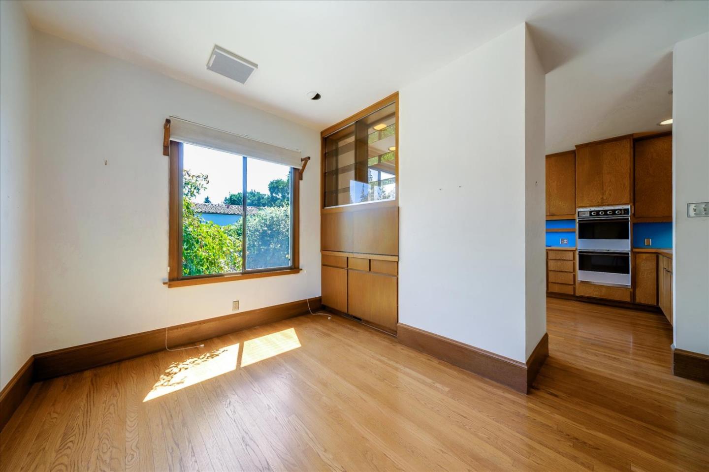 167 Almendral Avenue Atherton, CA 94027 - Photo 18 of 50 a view of an empty room with a window and wooden floor