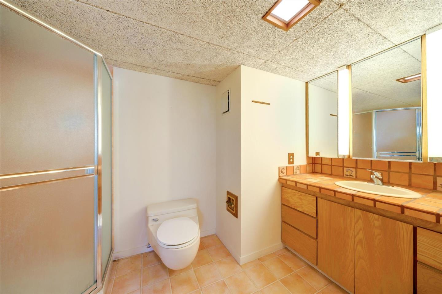 167 Almendral Avenue Atherton, CA 94027 - Photo 29 of 50 a bathroom with a toilet a sink and mirror